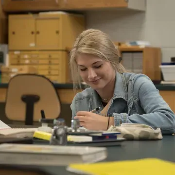 UW-Eau Claire – Barron County student takes note during science lab.